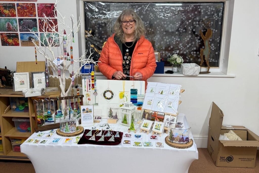 A festive stall with handmade glass Christmas decorations at a Rowans Day Nursery Christmas fete