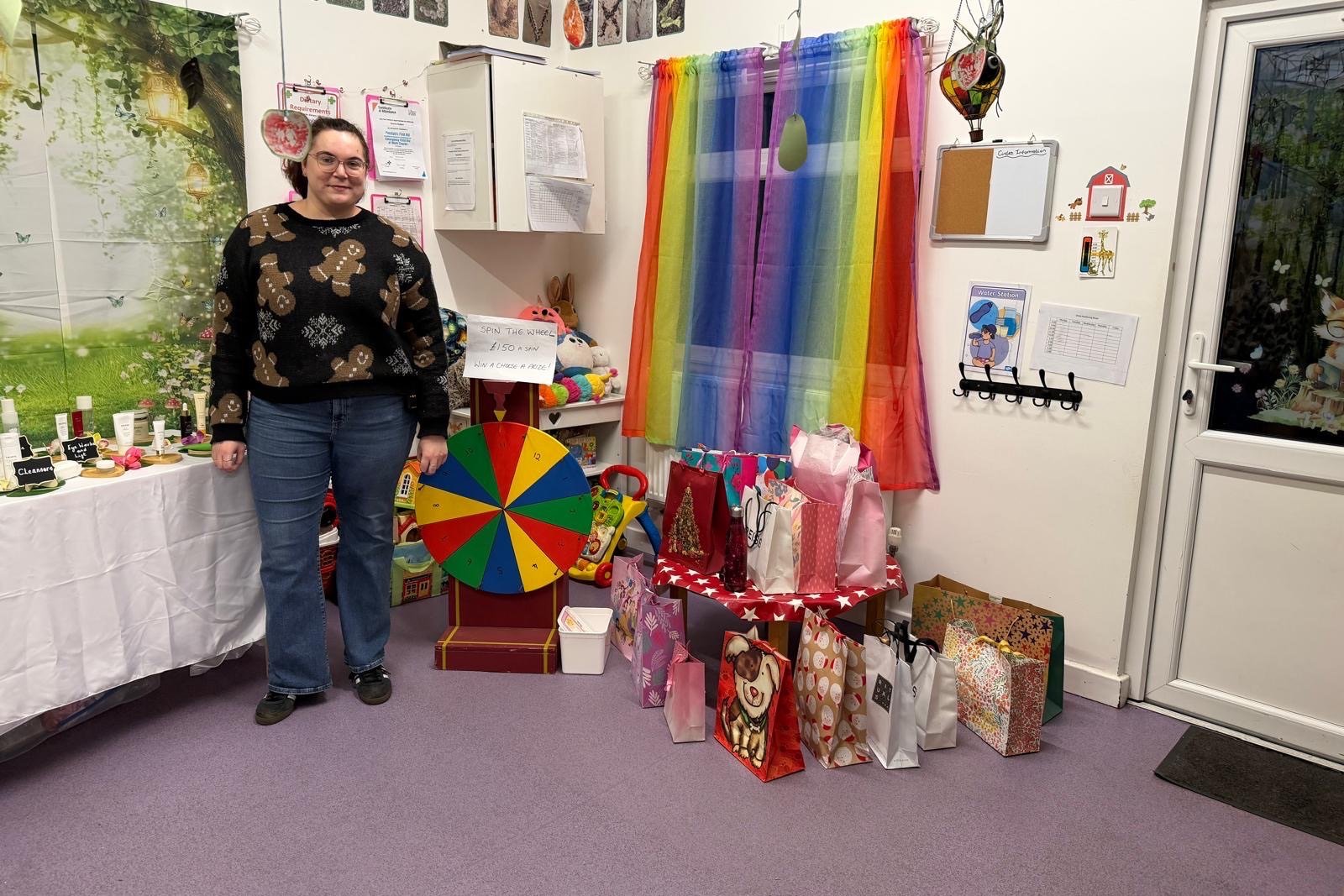 Spin the wheel game and bags of prizes at a Rowans Day Nursery Christmas fete